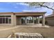 Backyard patio with a beautiful stone design and access to the house at 9514 E Cavalry Dr, Scottsdale, AZ 85262