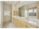 Double vanity bathroom with large mirror and natural light at 9514 E Cavalry Dr, Scottsdale, AZ 85262