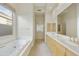 Bathroom with double vanity, soaking tub, and separate shower at 9514 E Cavalry Dr, Scottsdale, AZ 85262