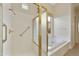Bathroom with shower, tub, and gold accents at 9514 E Cavalry Dr, Scottsdale, AZ 85262