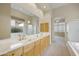 Double vanity bathroom with a large mirror and marble countertops at 9514 E Cavalry Dr, Scottsdale, AZ 85262