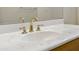 Bathroom vanity with marble countertop and gold fixtures at 9514 E Cavalry Dr, Scottsdale, AZ 85262