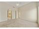 Spacious carpeted bedroom with ceiling fan and ensuite bathroom access at 9514 E Cavalry Dr, Scottsdale, AZ 85262
