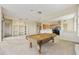 Game room features a pool table and built-in shelving at 9514 E Cavalry Dr, Scottsdale, AZ 85262