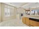 Bright kitchen with white tile floors and built-in appliances at 9514 E Cavalry Dr, Scottsdale, AZ 85262