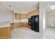 Modern kitchen featuring a breakfast bar and black appliances at 9514 E Cavalry Dr, Scottsdale, AZ 85262