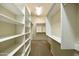Spacious walk-in closet with custom shelving and hanging rods at 9514 E Cavalry Dr, Scottsdale, AZ 85262