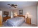 Spacious bedroom with ceiling fan, double closets, and wood furniture at 9614 N 110Th Ave, Sun City, AZ 85351