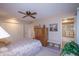 Main bedroom with ceiling fan, large closet, and en-suite bathroom at 9614 N 110Th Ave, Sun City, AZ 85351