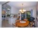 Bright dining room adjacent to kitchen, featuring a round table and chairs at 9614 N 110Th Ave, Sun City, AZ 85351