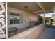Covered front porch with brick columns and a tiled floor at 9614 N 110Th Ave, Sun City, AZ 85351