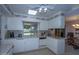 Eat-in kitchen with granite counters, white cabinets, and view to backyard at 9614 N 110Th Ave, Sun City, AZ 85351