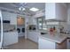Bright kitchen with white cabinets, ample counter space, and laundry area at 9614 N 110Th Ave, Sun City, AZ 85351