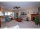 Living room with comfortable seating, a coffee table, and a ceiling fan at 9614 N 110Th Ave, Sun City, AZ 85351