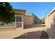 Side yard with screened porch and view of wall at 10529 W Pineaire Dr, Sun City, AZ 85351