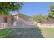 Home exterior and fenced backyard with citrus trees at 10529 W Pineaire Dr, Sun City, AZ 85351