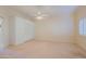 Bright bedroom with a ceiling fan and built-in wardrobe at 10529 W Pineaire Dr, Sun City, AZ 85351