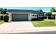 Attached garage with a green door and a spacious driveway at 10529 W Pineaire Dr, Sun City, AZ 85351