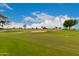 Expansive view of a putting green and sand trap at 10529 W Pineaire Dr, Sun City, AZ 85351