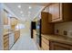 Galley kitchen with light wood cabinets and modern appliances at 10529 W Pineaire Dr, Sun City, AZ 85351
