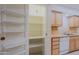 Well-organized pantry with ample shelving for storage at 10529 W Pineaire Dr, Sun City, AZ 85351