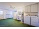 Interior laundry room with washer, dryer, sink, and cabinets at 10529 W Pineaire Dr, Sun City, AZ 85351