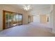 Spacious living area with sliding glass doors and high ceilings at 10529 W Pineaire Dr, Sun City, AZ 85351