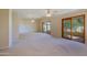 Open living space with large windows and access to a patio at 10529 W Pineaire Dr, Sun City, AZ 85351