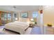Spacious primary bedroom with large windows and sliding glass doors at 10529 W Pineaire Dr, Sun City, AZ 85351