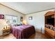 Spacious bedroom with large bed, wood dresser, and TV at 11596 W Sierra Dawn Blvd # 134, Surprise, AZ 85378