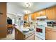 Bright kitchen with oak cabinets, island, and appliances at 11596 W Sierra Dawn Blvd # 134, Surprise, AZ 85378