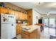 Cozy kitchen with oak cabinets, island, and access to backyard at 11596 W Sierra Dawn Blvd # 134, Surprise, AZ 85378