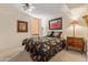 Bedroom with floral bedding and antique nightstand at 1412 E Commodore Pl, Tempe, AZ 85283