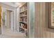 Hallway with built-in bookshelves and artwork at 1412 E Commodore Pl, Tempe, AZ 85283