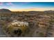 Aerial view of a large estate at sunset with desert landscape at 14236 E Ranch Rd, Scottsdale, AZ 85262