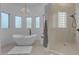 Luxurious bathroom with freestanding tub, chandelier, and glass shower at 14236 E Ranch Rd, Scottsdale, AZ 85262