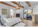 Bedroom with a fireplace and sliding glass doors to patio at 14236 E Ranch Rd, Scottsdale, AZ 85262