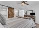 Bright bedroom with rustic barn door and cozy bedding at 14236 E Ranch Rd, Scottsdale, AZ 85262