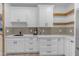 Modern coffee bar with white cabinets and wood shelving at 14236 E Ranch Rd, Scottsdale, AZ 85262