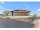 Detached two-car garage with brown metal exterior at 14236 E Ranch Rd, Scottsdale, AZ 85262