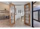 Home bar area with wooden doors opening to a home office at 14236 E Ranch Rd, Scottsdale, AZ 85262