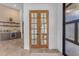 Home bar with wooden doors leading to an office or study at 14236 E Ranch Rd, Scottsdale, AZ 85262