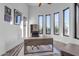 Spacious home office with large windows, wood desk, and a ceiling fan at 14236 E Ranch Rd, Scottsdale, AZ 85262