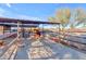 Horse stable with a shaded area and feeding troughs at 14236 E Ranch Rd, Scottsdale, AZ 85262