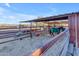 Horse stable with individual stalls and a shaded area at 14236 E Ranch Rd, Scottsdale, AZ 85262