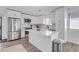 Modern kitchen with white cabinets, island, and stainless steel appliances at 14236 E Ranch Rd, Scottsdale, AZ 85262