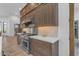 Range, oven, and custom wood cabinets in kitchen at 14236 E Ranch Rd, Scottsdale, AZ 85262