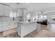 Open concept kitchen with white cabinets and island at 14236 E Ranch Rd, Scottsdale, AZ 85262