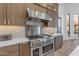 Stainless steel range and oven with custom cabinetry at 14236 E Ranch Rd, Scottsdale, AZ 85262