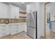 Modern kitchen features white cabinets, stainless steel appliances, and wood shelving at 14236 E Ranch Rd, Scottsdale, AZ 85262